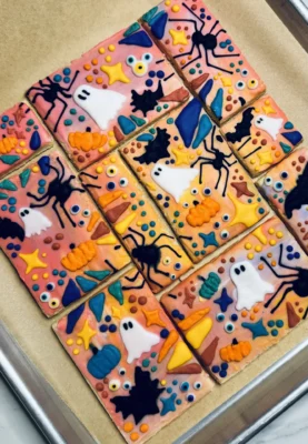 Halloween cookie puzzle with ghosts, spiders, bats, pumpkins, and other spooky pictures