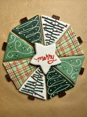 Christmas cookies with assorted Christmas trees and a star in the middle with the word "merry"